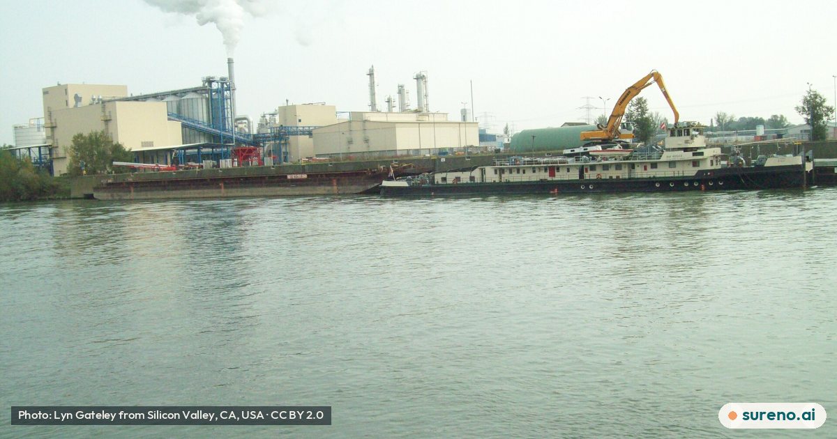 Factory, crane, and long, low vessel, on the Danube.jpg